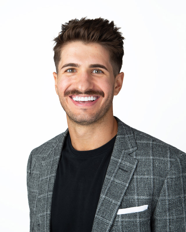 a man with a mustache and a suit jacket