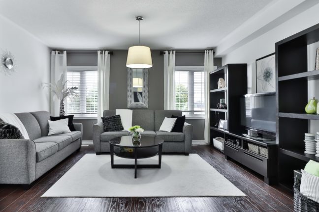 a living room filled with furniture and a flat screen tv