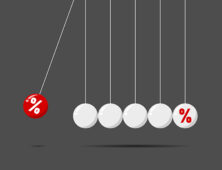 a number of balls hanging from a line with a percentage sign.