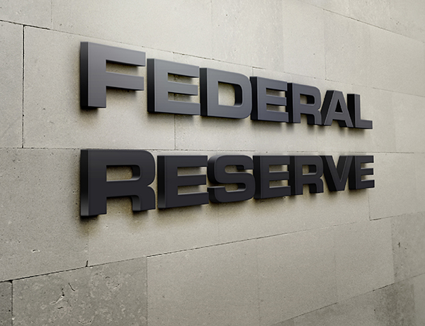 the federal reserve sign on the side of a building.